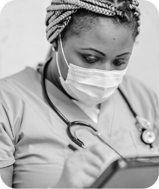 A doctor writing notes on a tablet