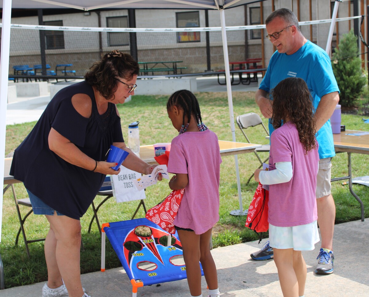 Volunteers with children playing games